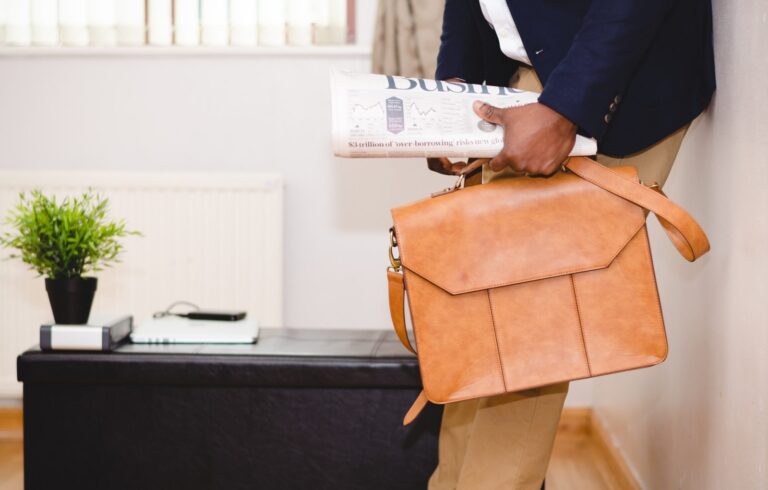 Man carrying newspaper and briefcase