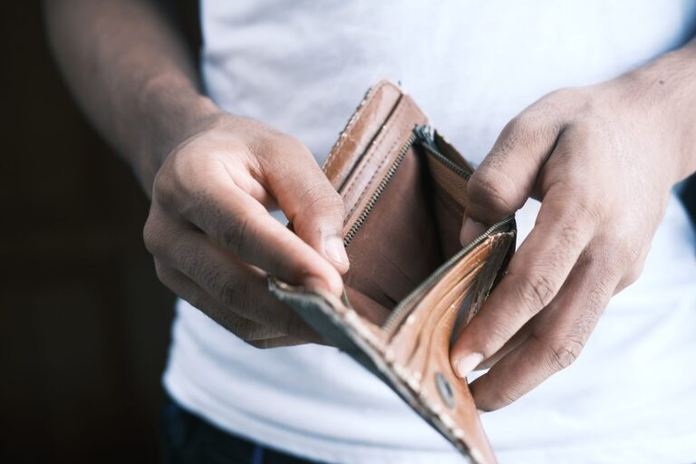 person holding empty wallet open