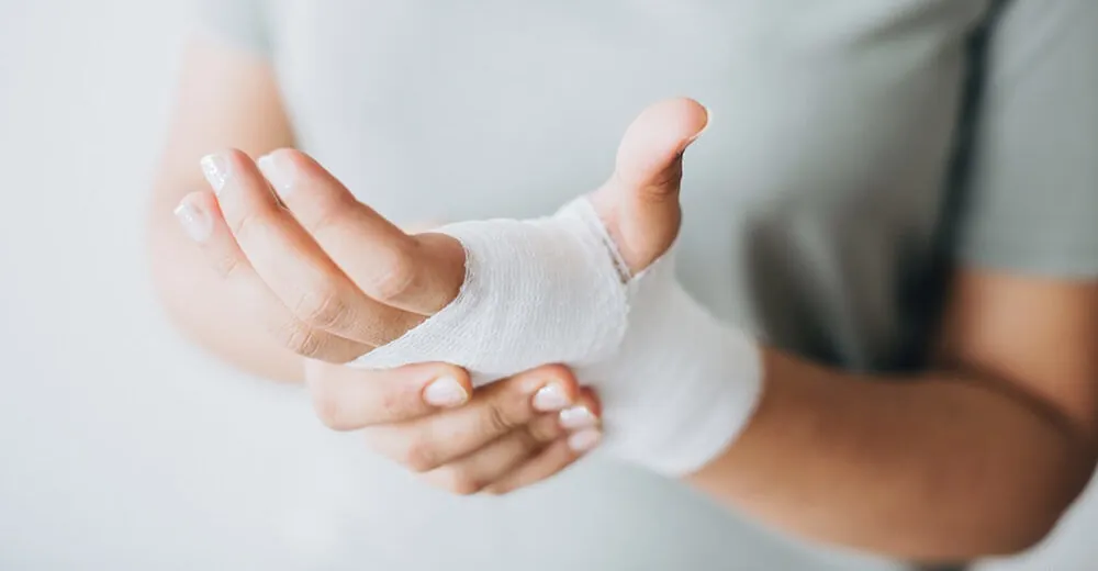 Woman with injured and bandaged hand