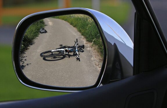 Fallen over bicycle in rear view mirror