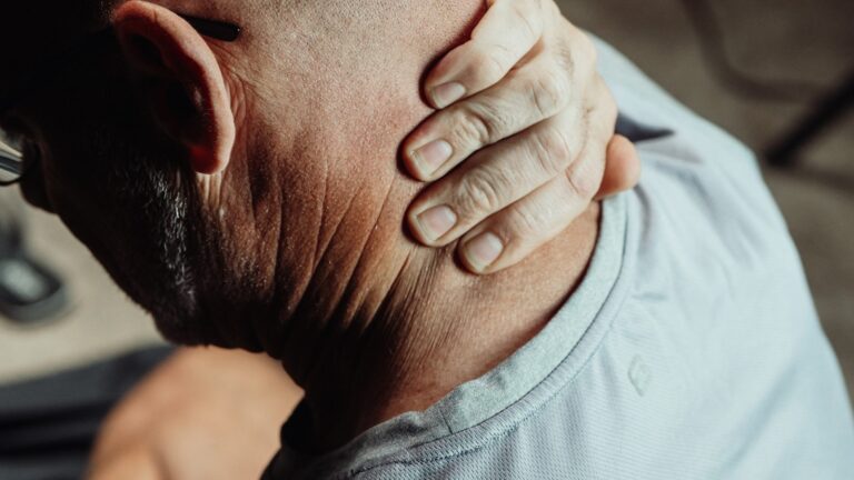 person holding back of neck