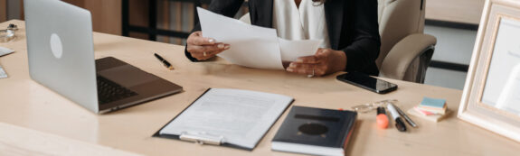 person looking at paperwork at desk